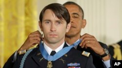 President Barack Obama awards the Medal of Honor to former Army Capt. William D. Swenson in the East Room at the White House, Oct. 15, 2013.