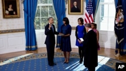 President Obama takes the oath of office at the official swearing-in ceremony in the Blue Room of the White House, January 20, 2013.