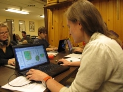 Abigail Larkin reviews a map database of information from Adirondack hiking trail registers at the State University of New York College of Environmental Science and Forestry research station in Newcomb, New York, on Wednesday, June 12, 2013.