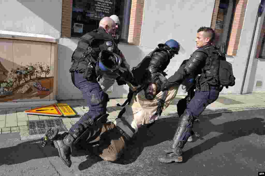 An environmental activist is arrested during clashes with Gendarmes in Gaillac, southwestern France. The activists hostile to the proposed dam in the nearby Sivens forest tried to supply food to the Zadists - the name given to the activists occupying the site "zone to defend," or ZAD, in spite of a blockade of pro-dam farmers on a road leading to the area.
