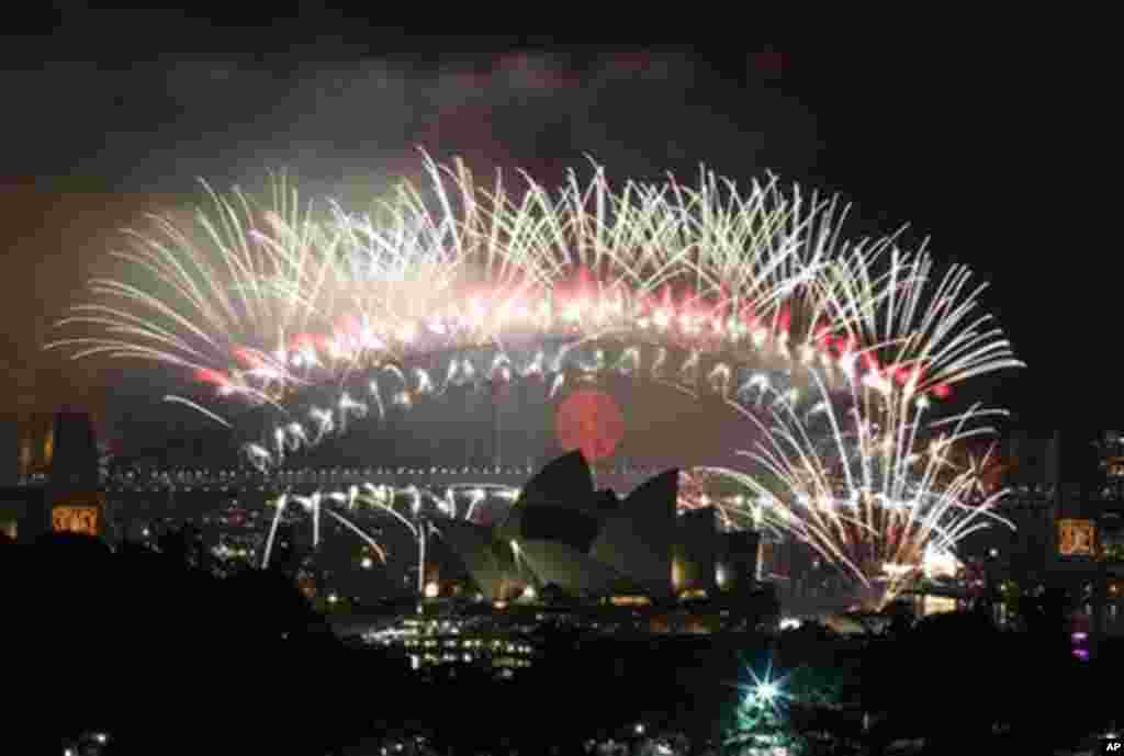 The sky above Sydney Harbour lights up at midnight during the fireworks display to celebrate the New Year's Day in Sydney, Australia, 01 Jan 2010. (AP Image)