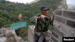 People work on the reconstruction of the Jiankou section of the Great Wall, in Huairou District, north of Beijing, China, June 7, 2017. 