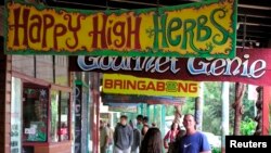 Shop signs along the main street of Australia's hippy capital Nimbin on April 12 promote the hippy way of life, which includes smoking marijuana. Australia hopes to soon export of medicinal marijuana and corner a piece of the lucrative world market.