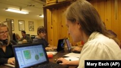 Abigail Larkin reviews a map database of information from Adirondack hiking trail registers at the State University of New York College of Environmental Science and Forestry research station in Newcomb, New York, on Wednesday, June 12, 2013. 