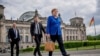 Chancellor Angela Merkel walks to the Chancellery, accompanied by her bodyguards, after the government questioning in the Bundestag in Berlin, Germany, May 13, 2020.