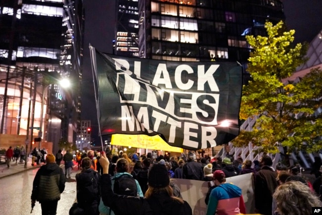 FILE - In this image from Nov. 4, 2020, Black Lives Matter protesters march in Seattle.