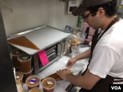 Jonathan Turcios says what he likes best about his job is being part of the chocolate-making team. (VOA Photo/J.Taboh)