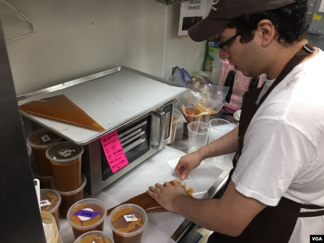 Jonathan Turcios says what he likes best about his job is being part of the chocolate-making team. (VOA Photo/J.Taboh)