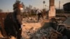 FILE - Kenneth Snowden, left, surveys the damage to his fire-ravaged property with his brother Ronnie in the aftermath of the Eaton fire, Jan. 10, 2025, in Altadena, Calif.