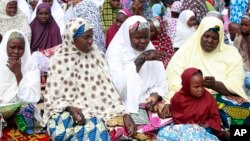 Nigeria Muslim women and girls attend Eid al-Fitr prayers at Ramat square in Maiduguri, Nigeria, Thursday, Aug. 8, 2013. Nigerians in the birthplace of an Islamic uprising gripping the northeast Thursday celebrated the Muslim holy day of Eid al-Fitr with