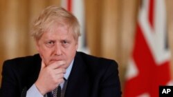 FILE: British Prime Minister Boris Johnson speaks during a press conference at Downing Street on the government's coronavirus action plan in London, March 3, 2020.