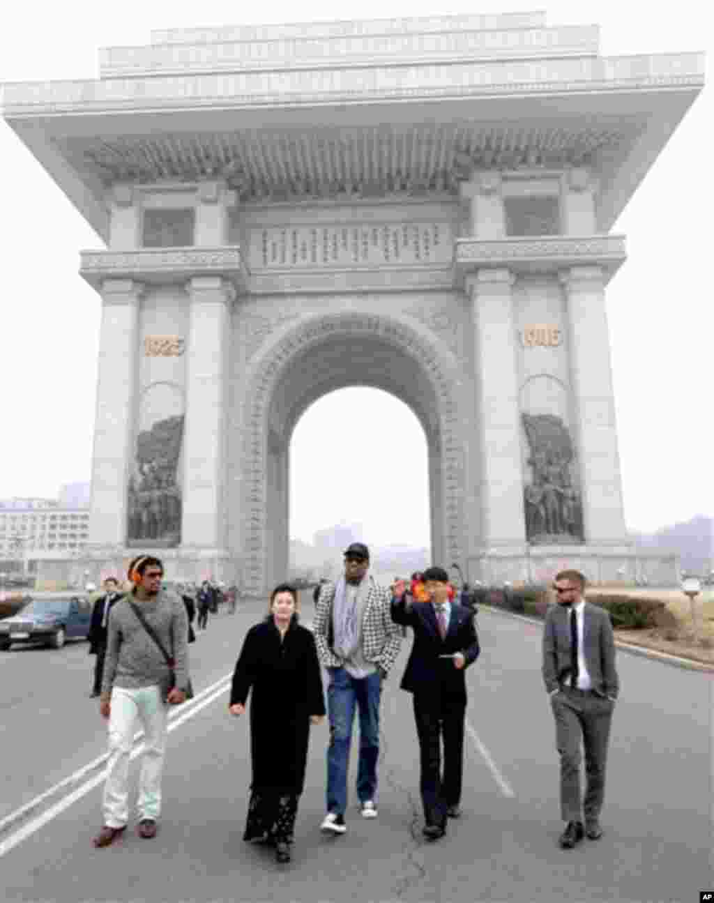 In this image released by the Korean Central News Agency (KCNA) and distributed by the Korea News Service, former NBA star Dennis Rodman, third right, visits the Arch of Triumph in Pyongyang in North Korea Friday, March 1 2013. 