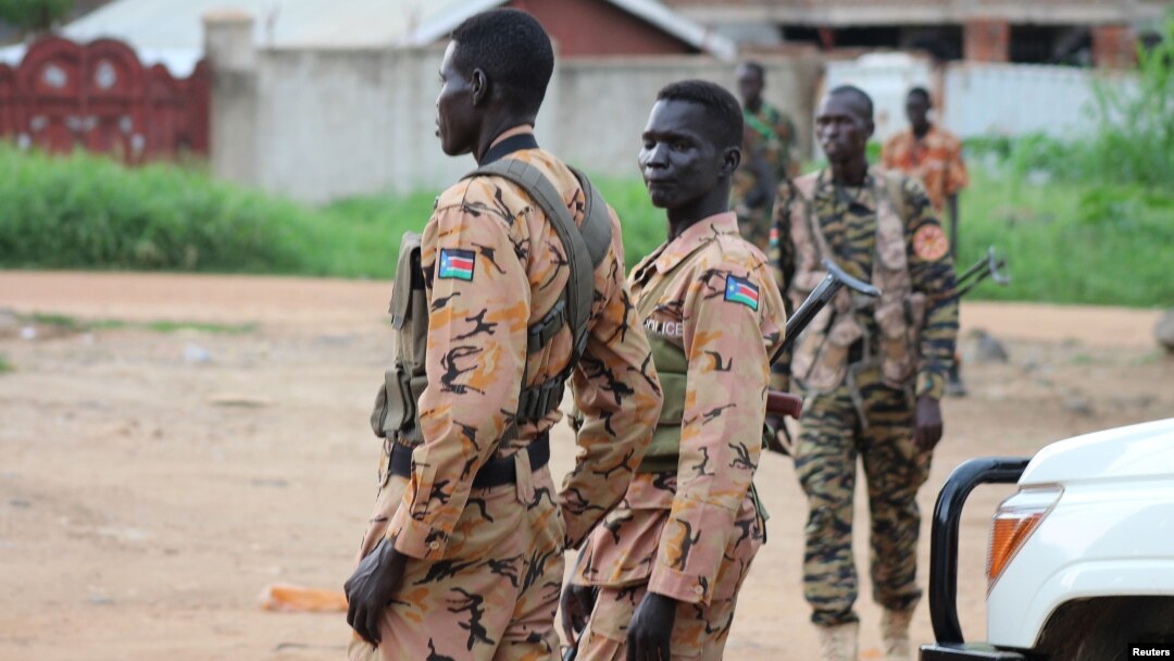 South Sudanese policemen and soldiers stand guard along a street following renewed fighting in South Sudan's capital Juba, July 10, 2016. 