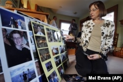 Jane Clementi, the mother of a Rutgers University student who killed himself, looks at family photographs.