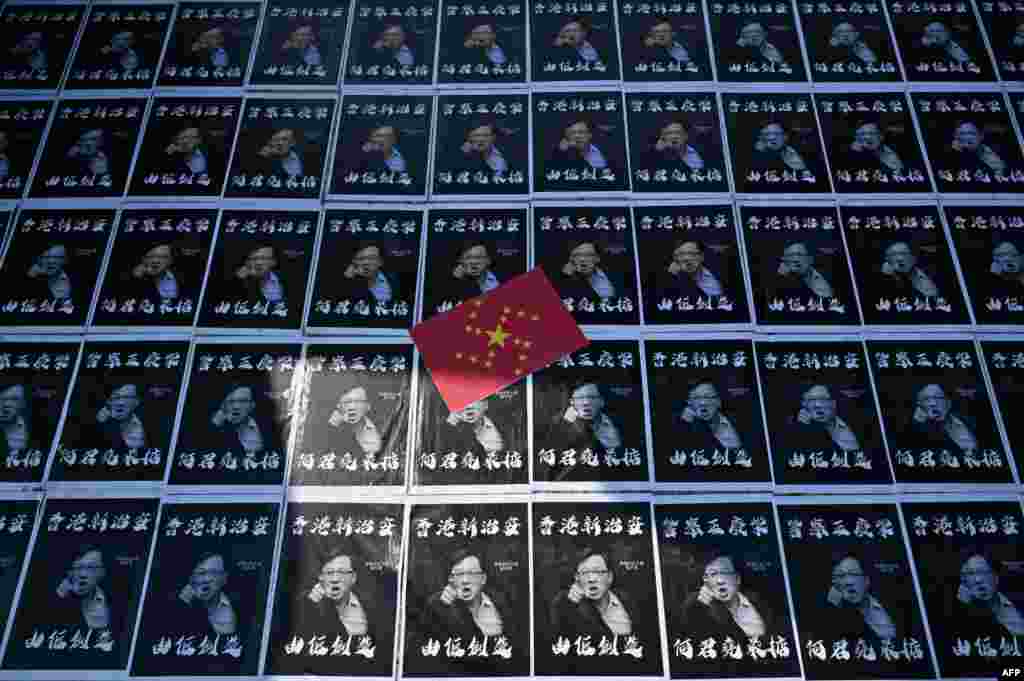 Posters of controversial pro-Beijing lawmaker Junius Ho are seen plastered onto paving stones in the grounds of the Chinese University of Hong Kong (CUHK), in Hong Kong.