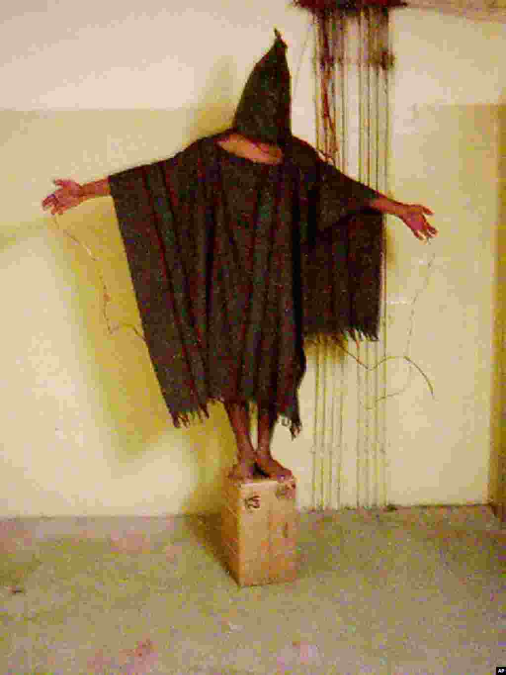 This image obtained by The Associated Press shows an unidentified detainee standing on a box with a bag on his head and wires attatched to him in late 2003 at the Abu Ghraib prison in Baghdad, Iraq. 