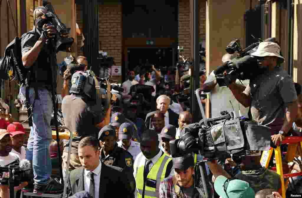 Oscar Pistorius leaves the North Gauteng High Court in Pretoria, Oct. 14, 2014. 