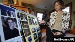 Jane Clementi, the mother of a Rutgers University student who killed himself, looks at family photographs.