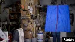 FILE - A voter casts his ballot inside the garage of Chobert Decorators during the U.S. presidential election in Philadelphia, Nov. 8, 2016. 