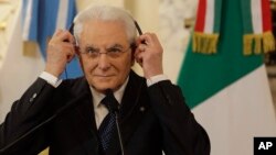 Italy's President Sergio Mattarella puts on headphone during a meeting with Argentina's President Mauricio Macri at the government house in Buenos Aires, Argentina, May 8, 2017.
