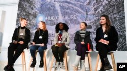 Climate activists Isabelle Axelsson, Loukina Tille, Vanessa Nakate, Greta Thunberg, and Luisa Neubaue,, from left, arrive for a news conference in Davos, Switzerland, Jan. 24, 2020.