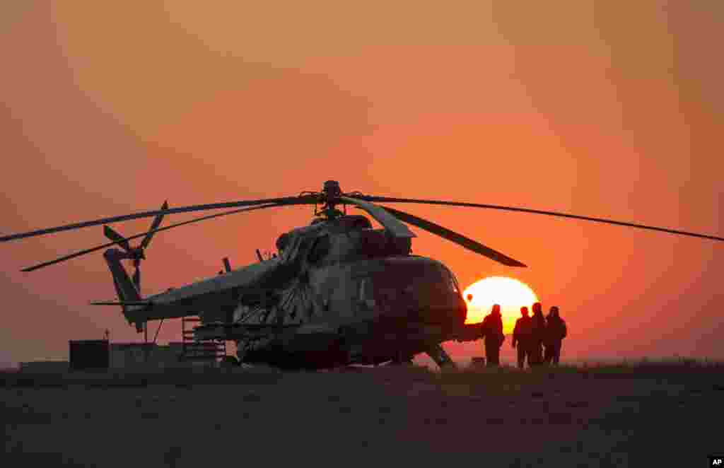 Ground support personnel wait for take off from Zhezkazgan, Kazakhstan to support the Soyuz TMA-12M spacecraft landing on Thursday, Sept. 11, 2014.