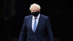 Britain's Prime Minister Boris Johnson visits the headquarters of Octopus Energy in London, Oct. 5, 2020.