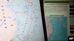 Computer screens display a map showing the outline of China's new air defense zone in the East China on the website of the Chinese Ministry of Defense, in Beijing Tuesday, Nov. 26, 2013.