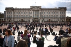 People gather outside Buckingham Palace after Britain's Prince Philip, husband of Queen Elizabeth, died at the age of 99, in London, Britain, April 9, 2021.