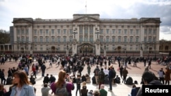 People gather outside Buckingham Palace after Britain's Prince Philip, husband of Queen Elizabeth, died at the age of 99, in London, Britain, April 9, 2021. 