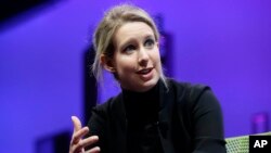 FILE - Elizabeth Holmes, founder and CEO of Theranos, speaks at the Fortune Global Forum in San Francisco, Nov. 2, 2015. Federal prosecutors said Friday they have indicted Holmes on criminal fraud charges for allegedly defrauding investors, doctors and patients.