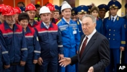 Kazakhstan's president and the main presidential candidate, Nursultan Nazarbayev, answers questions while speaking to workers during the opening of the "Moscow" subway station of the Almaty metro system in Almaty, Kazakhstan, April 18, 2015.