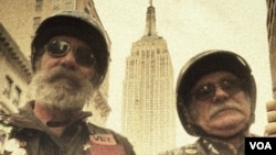 Vietnam-era veteran Frank Mulholland (right) and his buddy in the New York Chapter of 'Nam Knights, rode up Fifth Avenue in the Veteran's Day Parade to honor all veterans in America's many wars, Nov. 11, 2013. (VOA/A. Phillips)