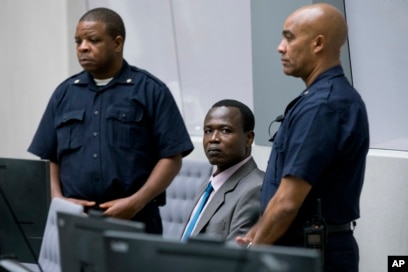 FILE - Dominic Ongwen, center, a senior commander in the Lord's Resistance Army, whose fugitive leader Kony is one of the world's most-wanted war crimes suspects, sits in the court room of the International Court in The Hague, Netherlands, Dec. 6, 2016.