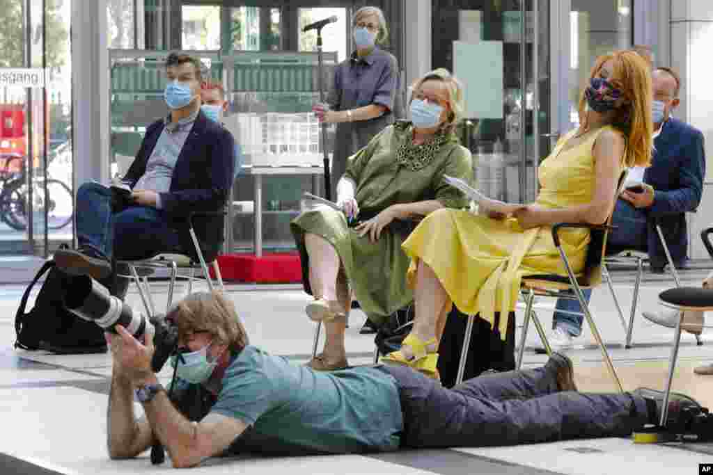 Journalists wear face mask and keep distance as they attend a news conference by German Health Minister Jens Spahn about the coronavirus crisis test strategy in Berlin.