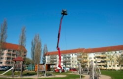 Musician Marcel Mainzer plays songs for his neighbors on a 21m high platform, during the coronavirus crisis in a residential area in Heilbad Heiligenstadt, Germany, April 8, 2020.