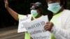 Annie Gordon, left, and Jenny Clark, rally for protection from evictions Saturday, June 27, 2020, in the Mattapan neighborhood of Boston. Massachusetts' tenant eviction moratorium is slated to expire in mid-August. (AP Photo/Michael Dwyer)