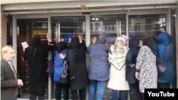 Iranian depositors protest a loss of their funds outside a branch of the Caspian Credit Institution in the northern city of Rasht, May 1, 2018.