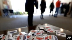 "I Voted" stickers are seen on a table at a polling station at Trinity Lutheran Church, in Evanston, Illinois, March 17, 2020. 