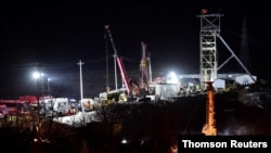 File - Rescue teams work on saving workers trapped underground after an explosion at the gold mine under construction in Qixia, China, Jan 19, 2021.