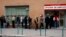 People wait in line to enter a government-run employment office in Madrid March 4, 2013.