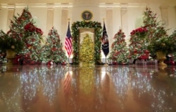 Holiday decor adorns the Cross Hall of the White House in Washington, U.S., November 30, 2020. REUTERS/Kevin Lamarque