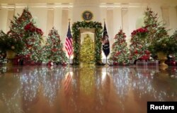 Holiday decor adorns the Cross Hall of the White House in Washington, U.S., November 30, 2020. REUTERS/Kevin Lamarque