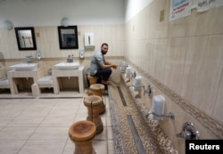 A Muslim believer washes his feet at a mosque, showing religious customs to a group of Hungarians who visited the mosque as part of an organized tour to see Budapest's Muslim community, Budapest, Hungary, Nov. 3, 2017.