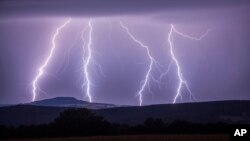 In this photo taken Wednesday, Aug. 9, 2017 a strike of lightning illuminates the sky over Annaberg-Buchholzer, southeastern Germany. (Bernd Maerz/dpa via AP)