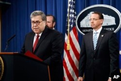 Attorney General William Barr speaks alongside Deputy Attorney General Rod Rosenstein, right, and Deputy Attorney General Ed O'Callaghan, rear left, about the release of a redacted version of special counsel Robert Mueller's report during a news conference at the Department of Justice, April 18, 2019.
