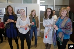 Pulitzer winners, left to right, Rachel Piper, Jessica Miller, Erin Alberty, Alex Stuckey and Sheila McCann from the Salt Lake Tribune, look on during a Pulitzer party in their newsroom, April 10, 2017, in Salt Lake City.