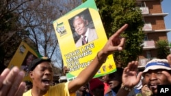 Members of the ruling party youth league sing outside the Mediclinic Heart Hospital where former South African President Nelson Mandela was being treated in Pretoria, South Africa, July 17, 2013. 