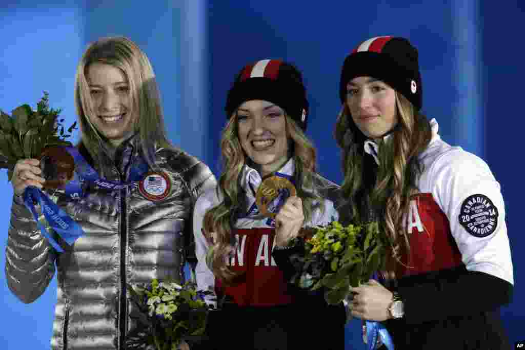 Women&#39;s mogul medalists from left, Hannah Kearney of the United States, bronze, Canada&#39;s Justine Dufour-Lapointe, gold, and her sister silver medalist Chloe Dufour-Lapointe pose during their medal ceremony at the 2014 Winter Olympics, Sochi, Russia, Feb. 9, 2014.