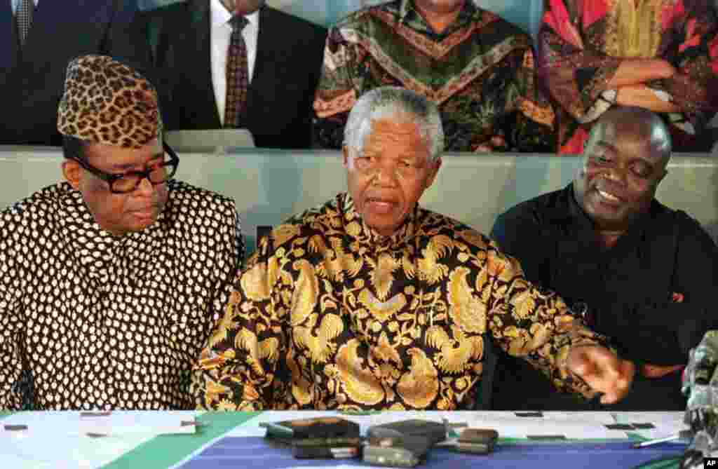 Le président sud-africain Nelson Mandela, au centre, médiateur de la crise congolaise anime une conférence de presse avec le président zaïrois Mobutu Sese Seko et le chef rebelle Laurent-Désiré Kabila, à bord du SAS Outeniqua dans le port de Pointe Noire.